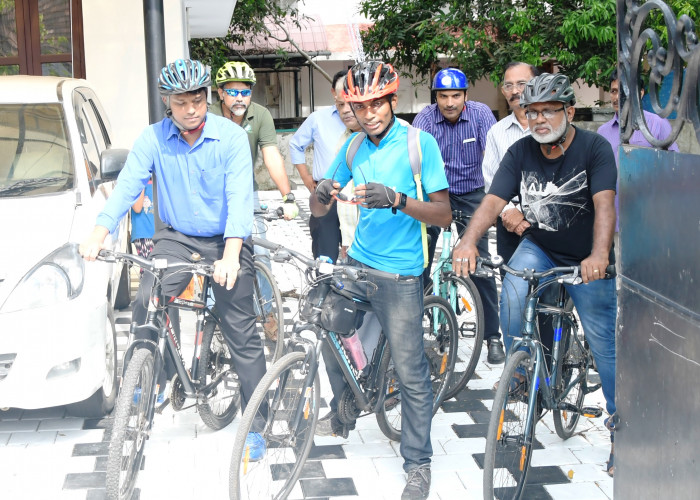 District Collector riding bicycle